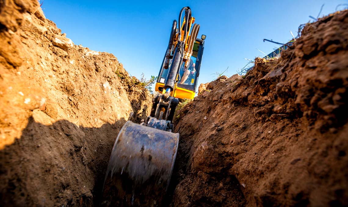 backhoe digging trench